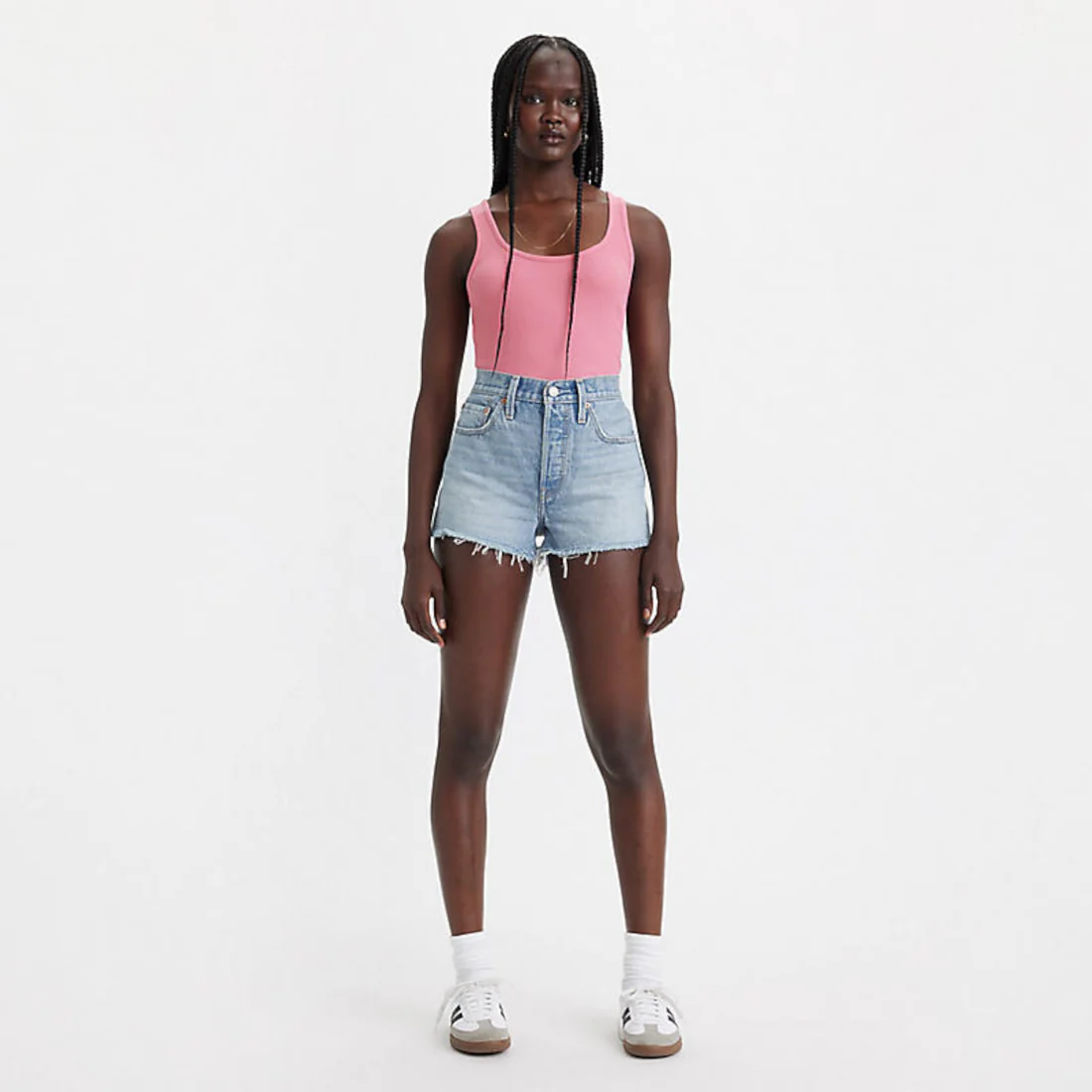 Levi’s 501 High Rise Frayed Hem Cut Off Shorts shown on model in light blue denim