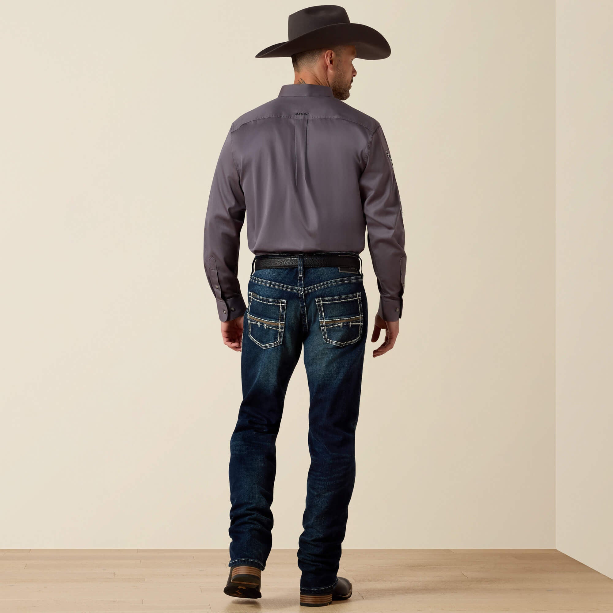Full body back view of Ariat M5 Slim Stretch Coltrane Stackable Straight Leg Jean on model with cowboy hat