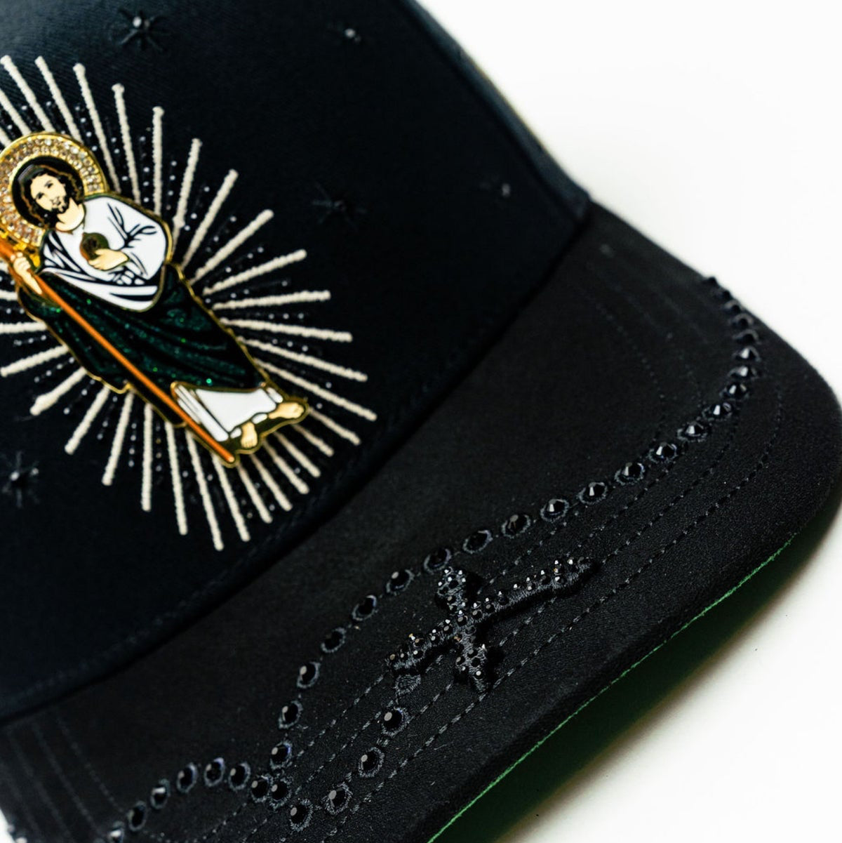 Angled close-up of Bigg Boss San Judas Cristal Black Hat brim and front patch