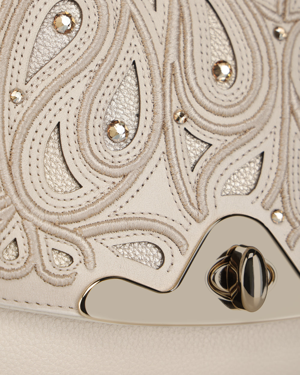 Close-up of embossed leather and crystal detail on Cuadra Women’s Beige Bovine Leather Shoulder Bag Clutch