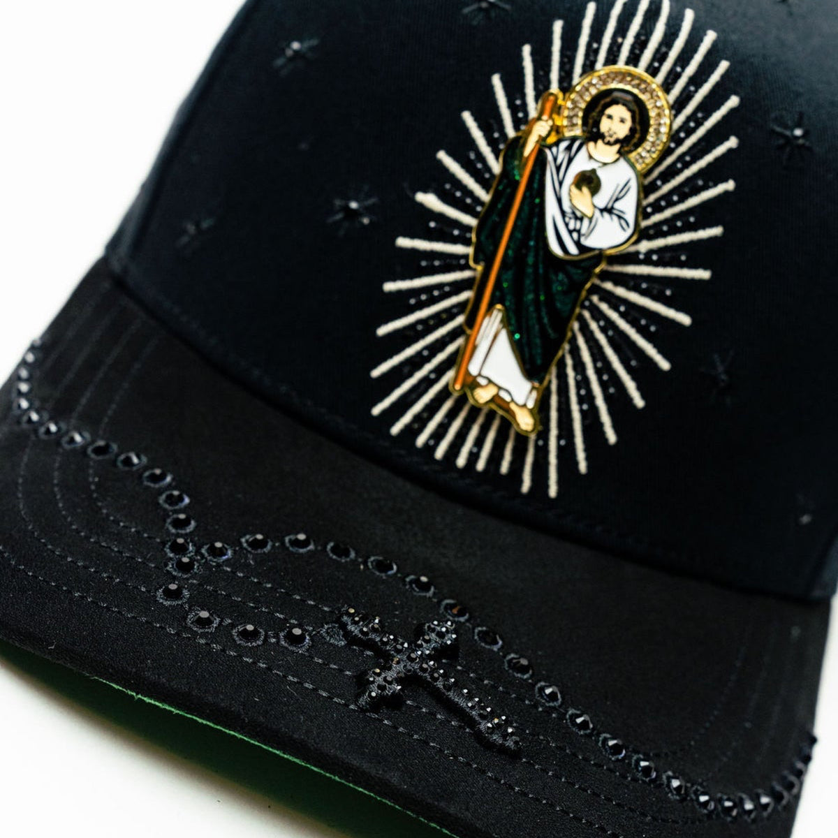 Angled close-up of Bigg Boss San Judas Cristal Black Hat brim and front patch