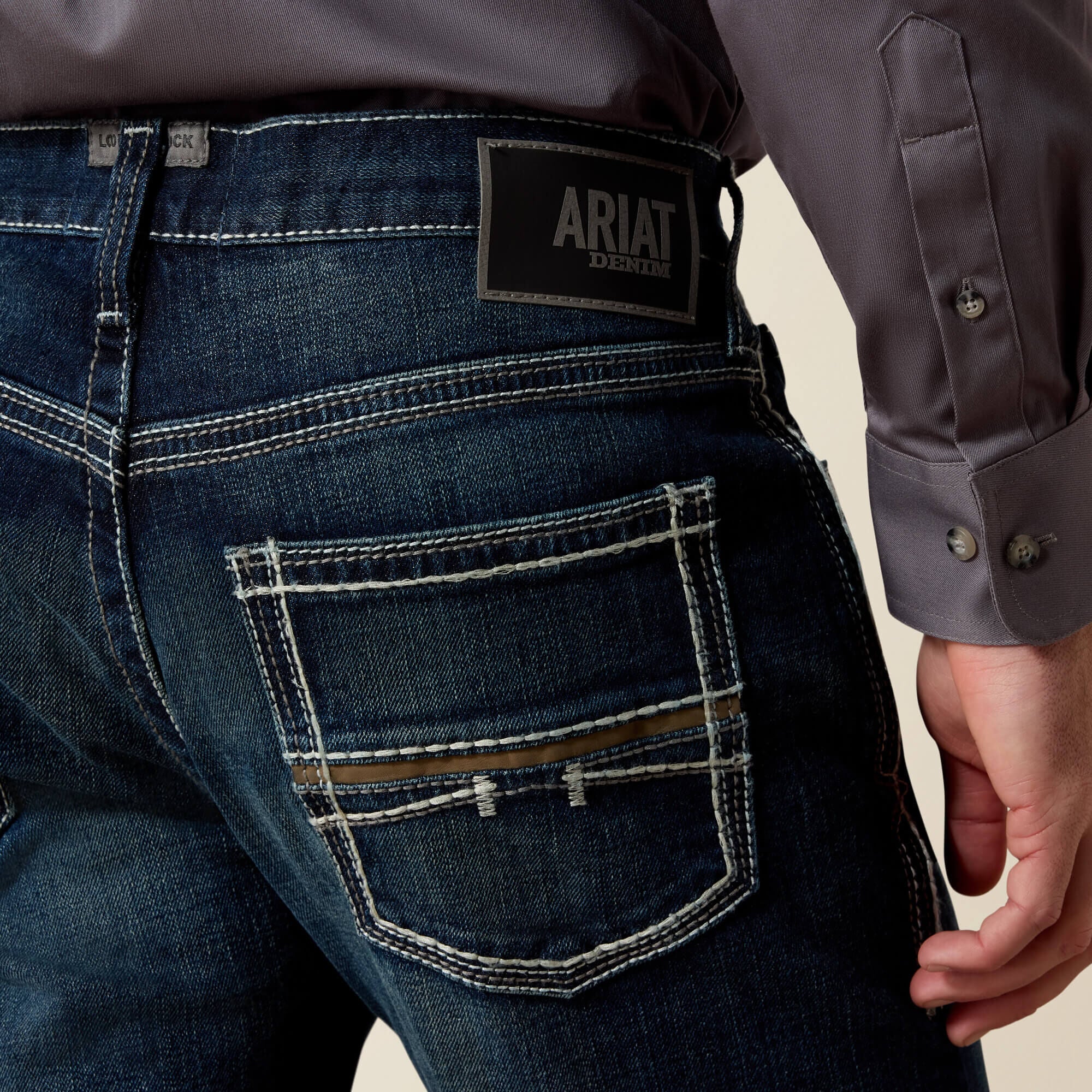 Rear close-up of Ariat M5 Slim Stretch Coltrane Stackable Straight Leg Jean pockets in blue denim
