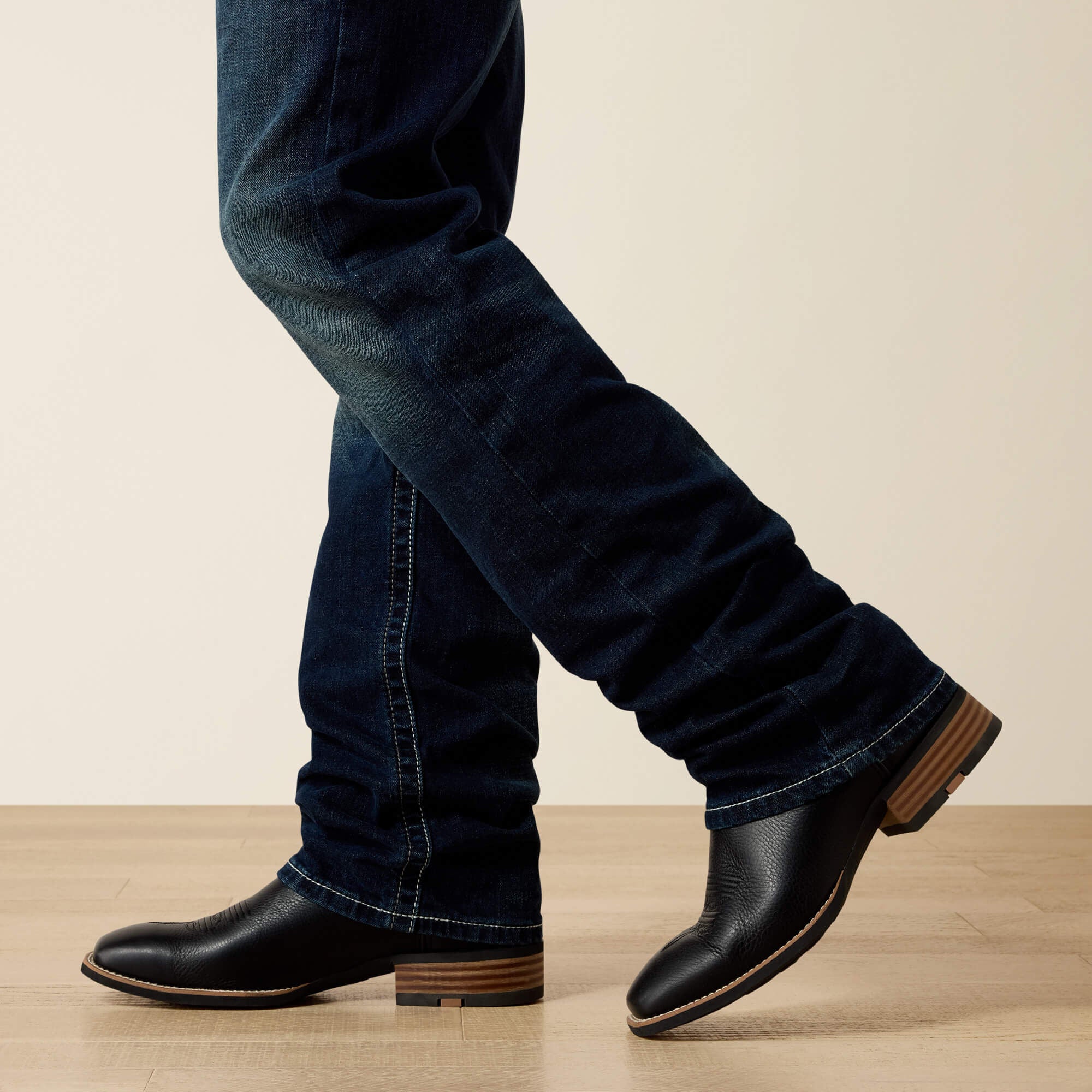 Side bottom view of Ariat M5 Slim Stretch Coltrane Stackable Straight Leg Jean stacked over boots