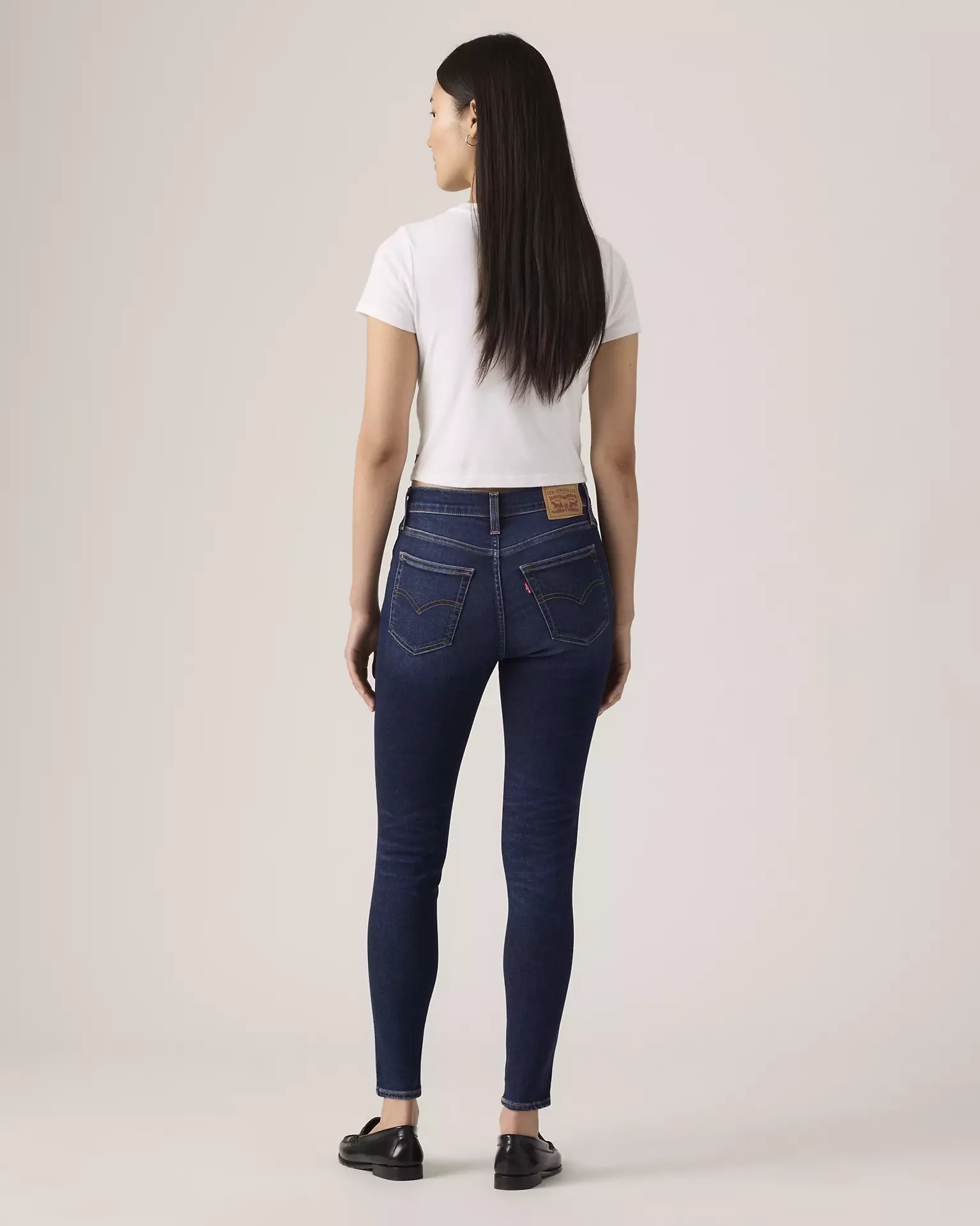Levi’s 720 High Rise Super Skinny Women’s Jeans back view on model in dark blue denim
