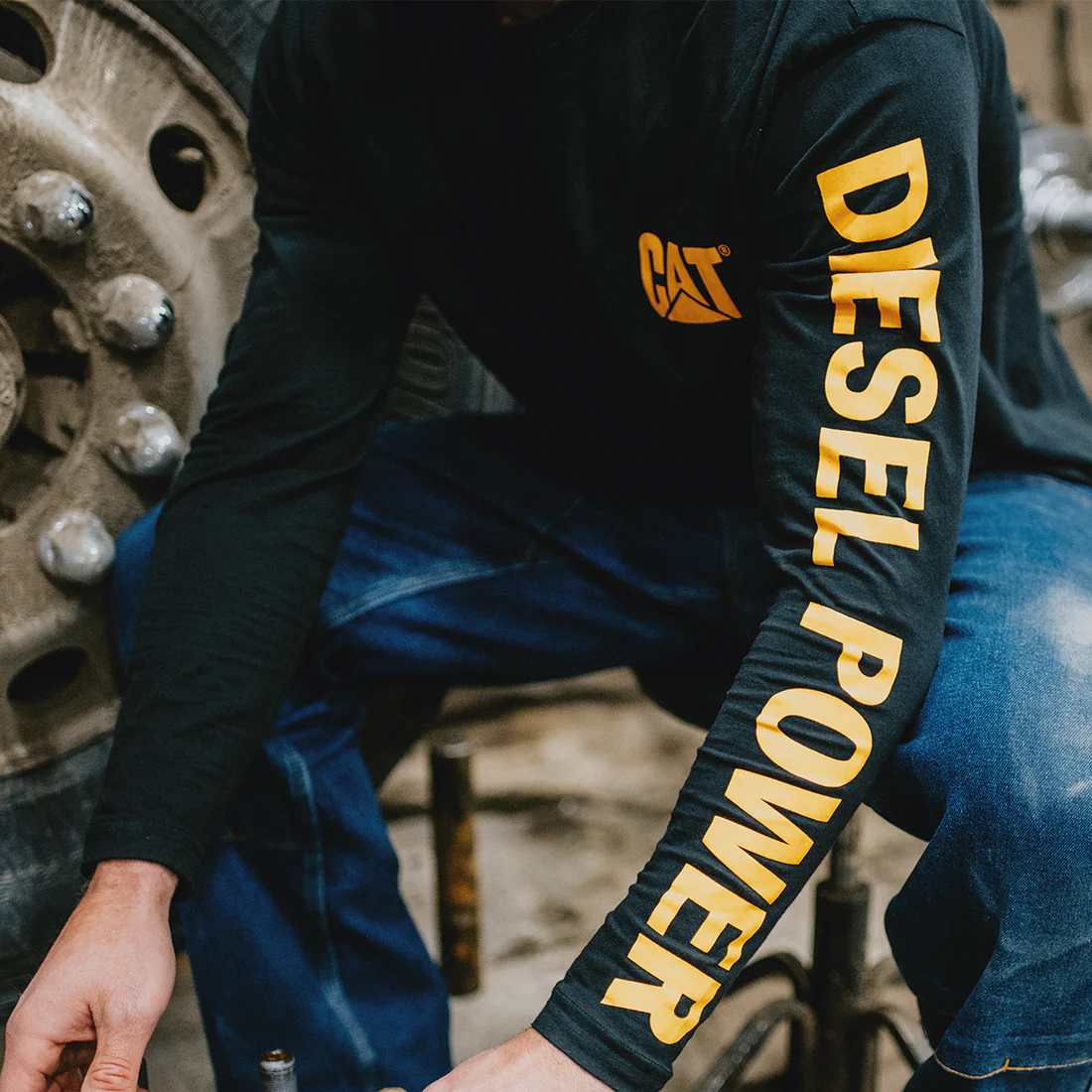 Close-up of CAT Diesel Power Long Sleeve T-Shirt sleeve graphic in black and yellow