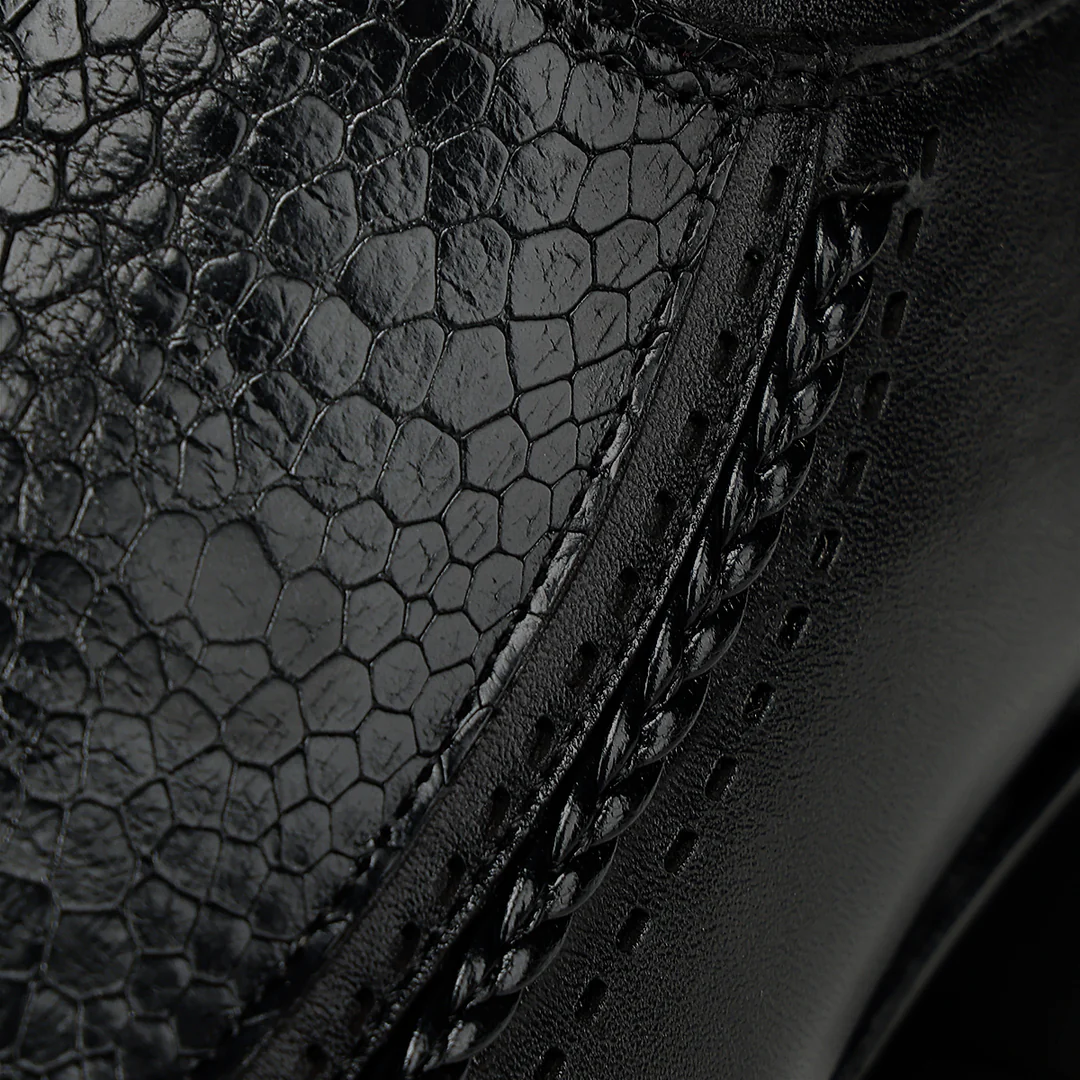 Close-up texture detail of black ostrich leg leather on Cuadra men’s boot